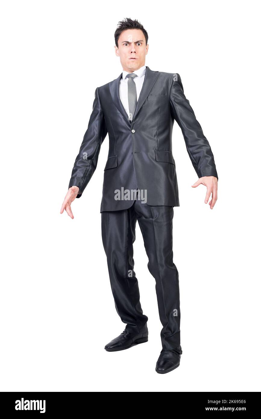 Surprised young businessman standing in studio and looking at camera Stock Photo