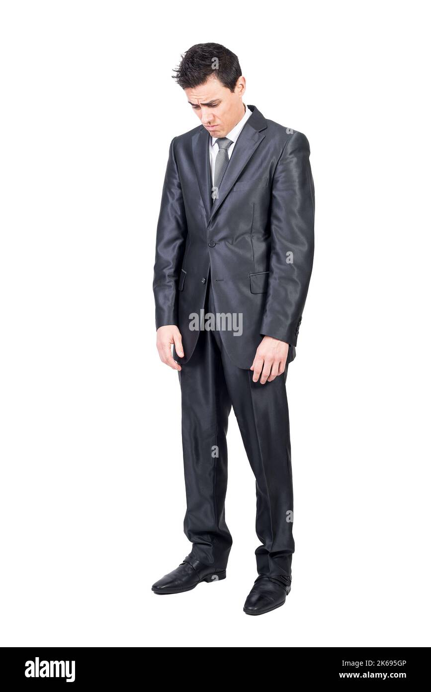 Sad young male manager looking down in white studio Stock Photo