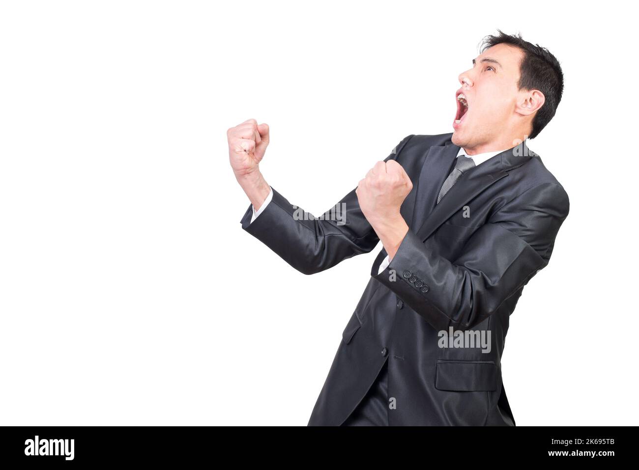 Excited Young Businessman Yelling While Celebrating Success In Studio excited-young-businessman-yelling-while-celebrating-success-in-studio