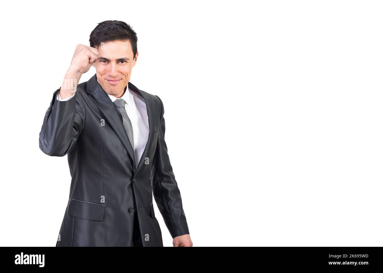 Successful young elegant guy showing fist gesture and smiling Stock Photo