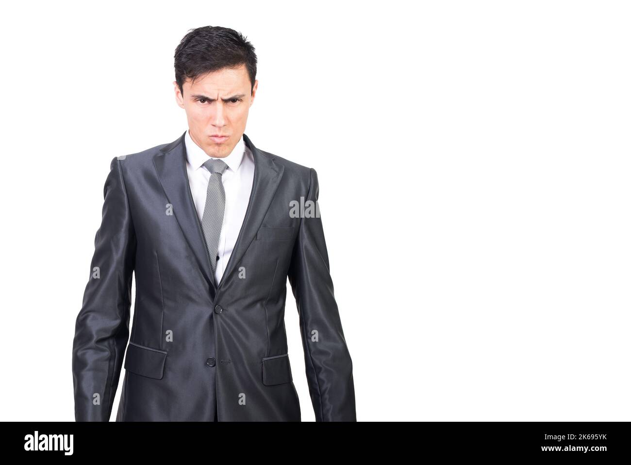 Serious young male manager looking at camera in white studio Stock Photo