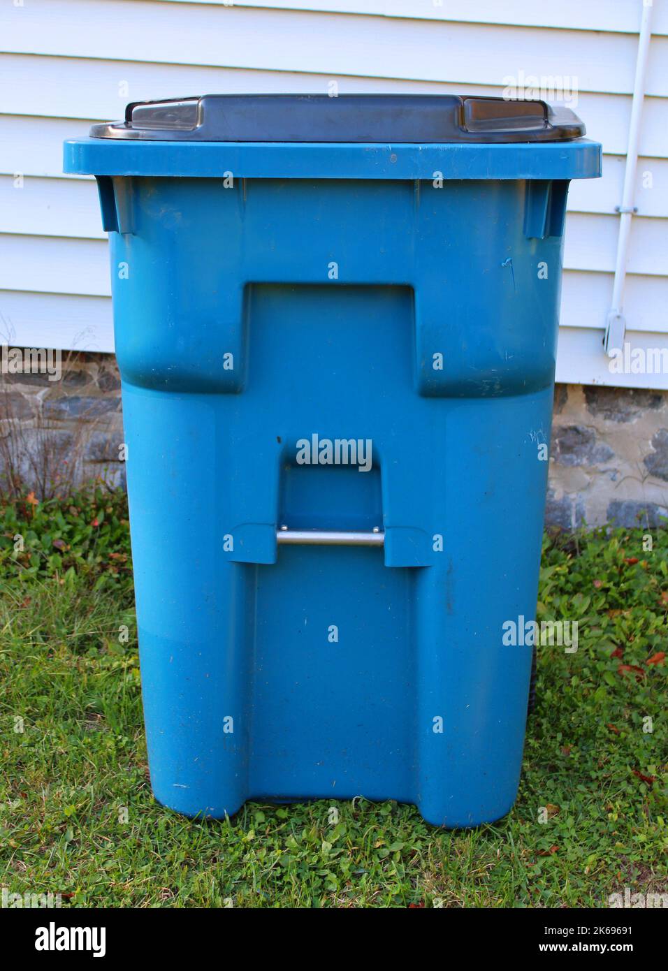 A Large Blue Plastic Trash Container Stock Photo