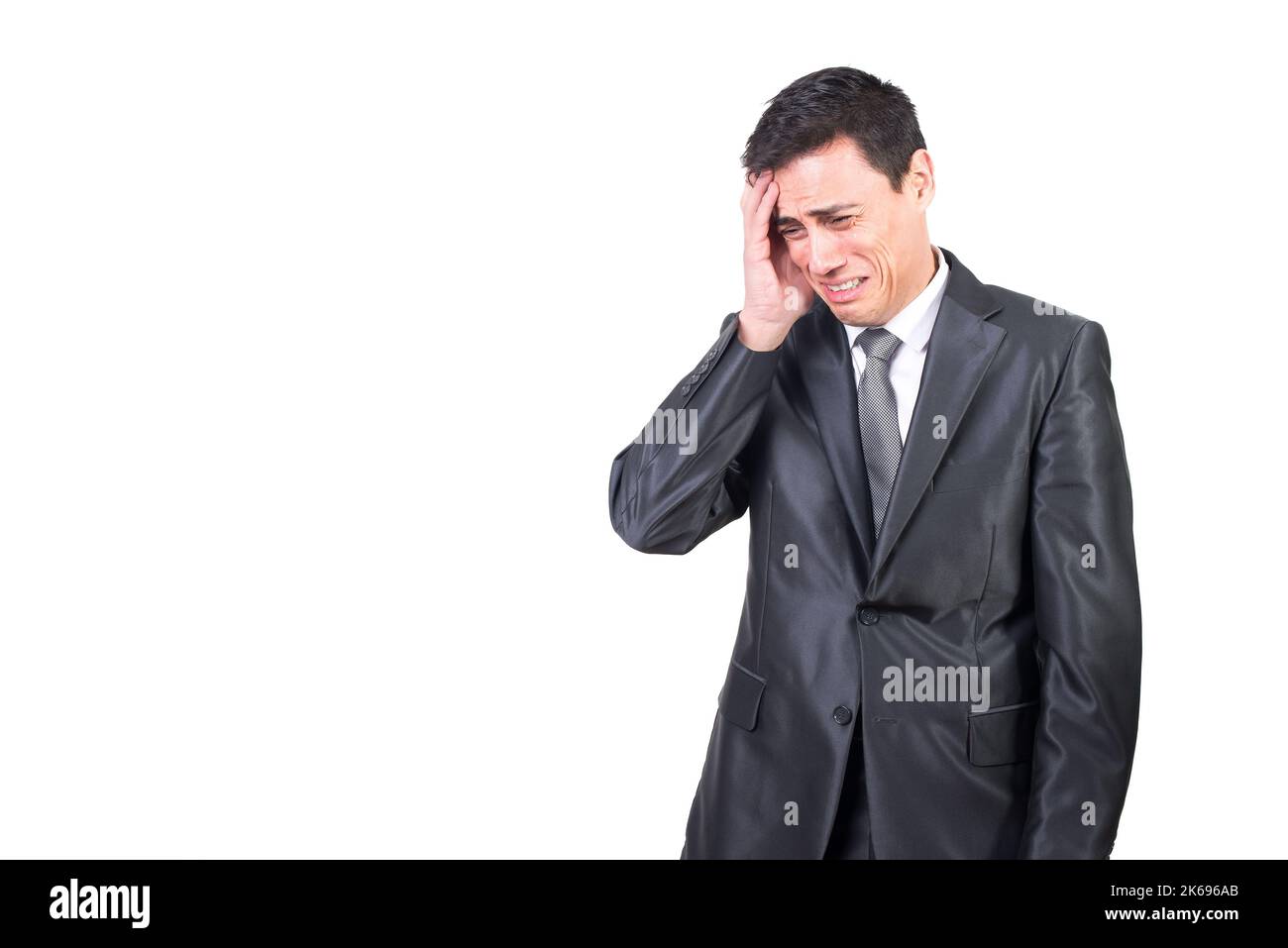 Crying man in formal suit touching head Stock Photo