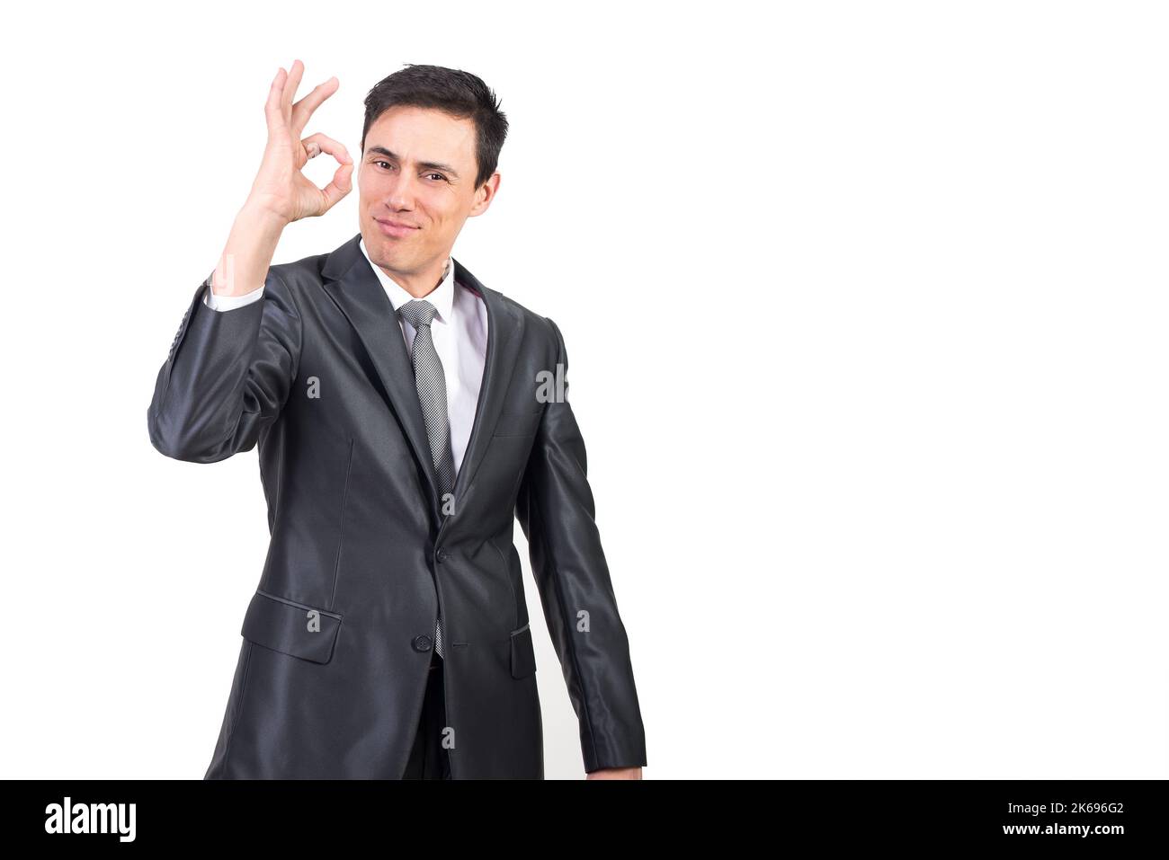 Cheerful businessman in suit showing OK gesture Stock Photo