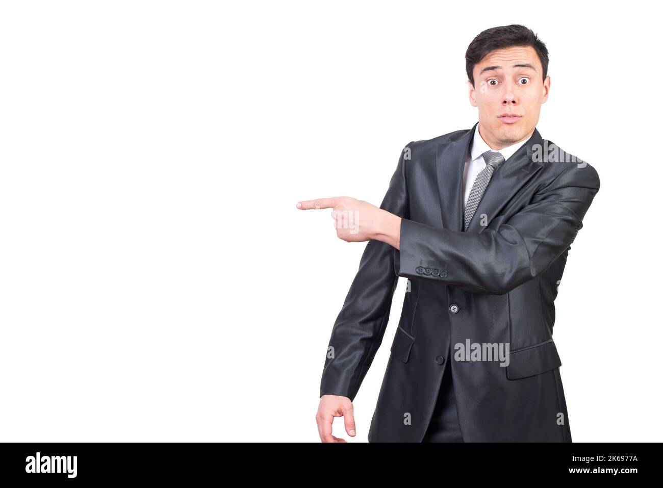 Confident young businessman pointing aside with surprise Stock Photo