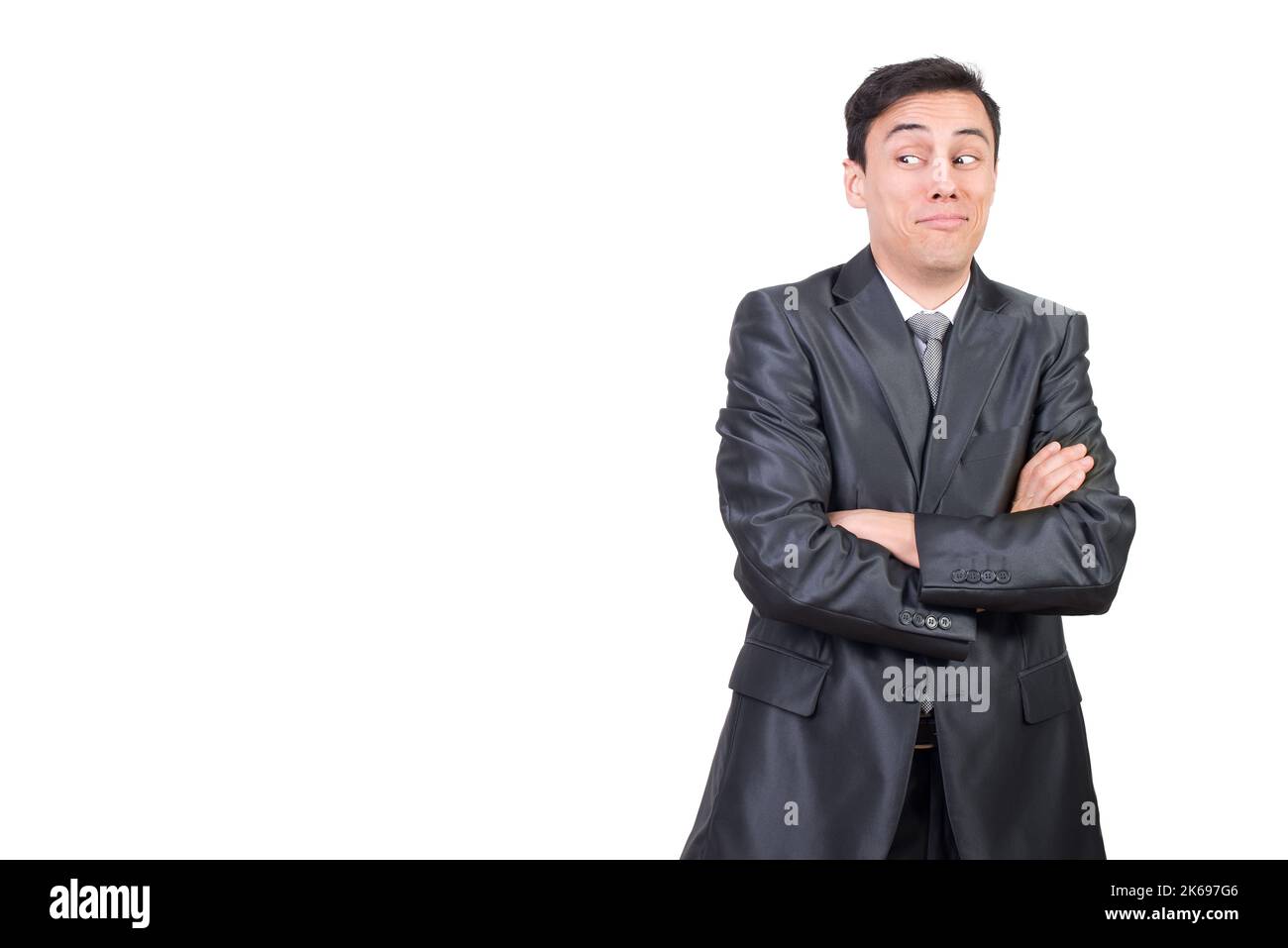 Surprised man in suit with crossed arms Stock Photo