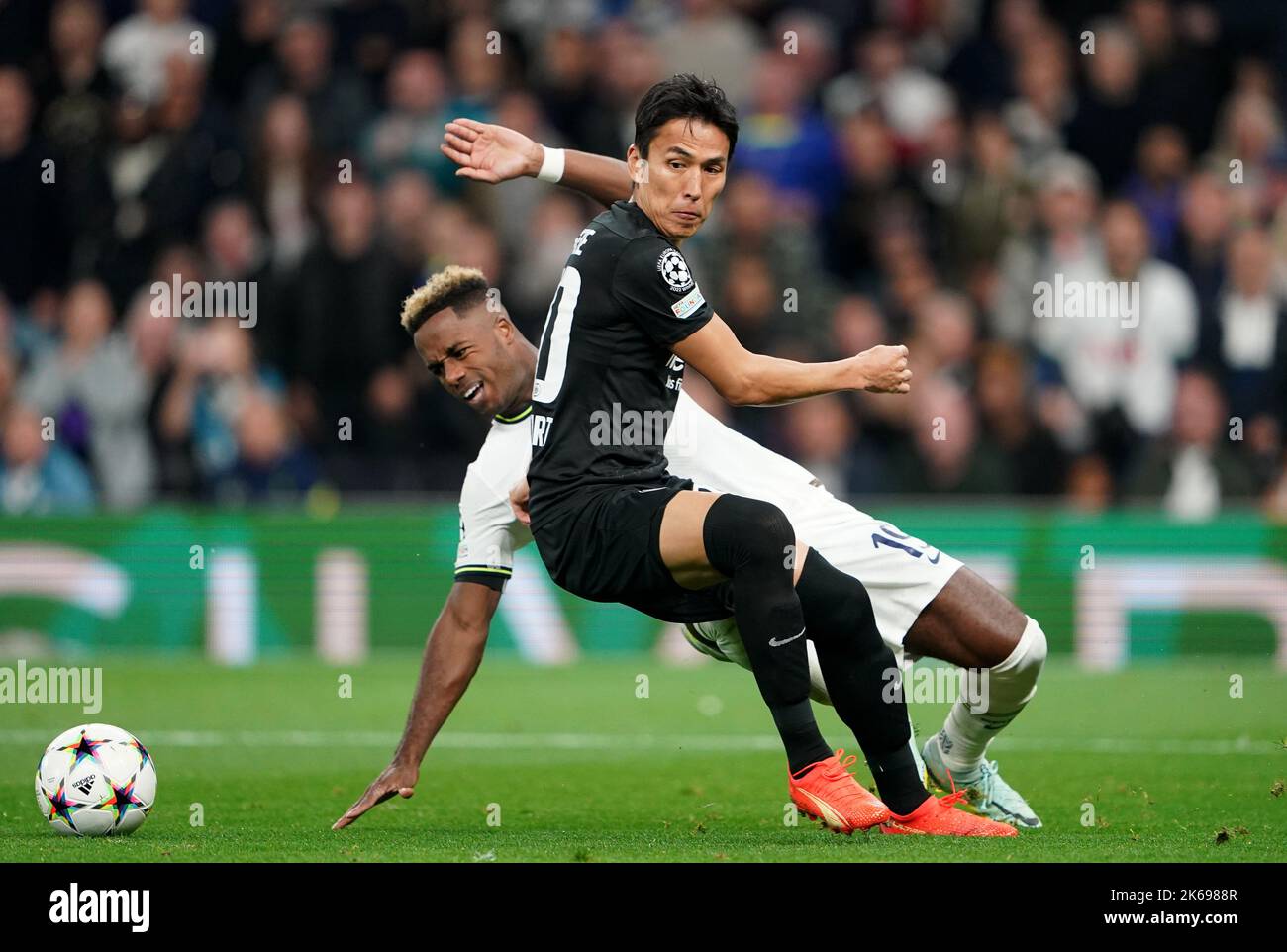 Tottenham Hotspur's Ryan Sessegnon (back) and Eintracht Frankfurt's Makoto Hasebe battle for the ball during the UEFA Champions League Group D match at the Tottenham Hotspur Stadium, London. Picture date: Wednesday October 12, 2022. Stock Photo