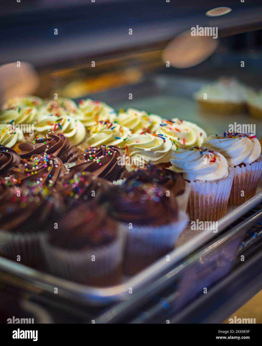 Different capcakes with chocolate and vanilla cream dessert. Peanut