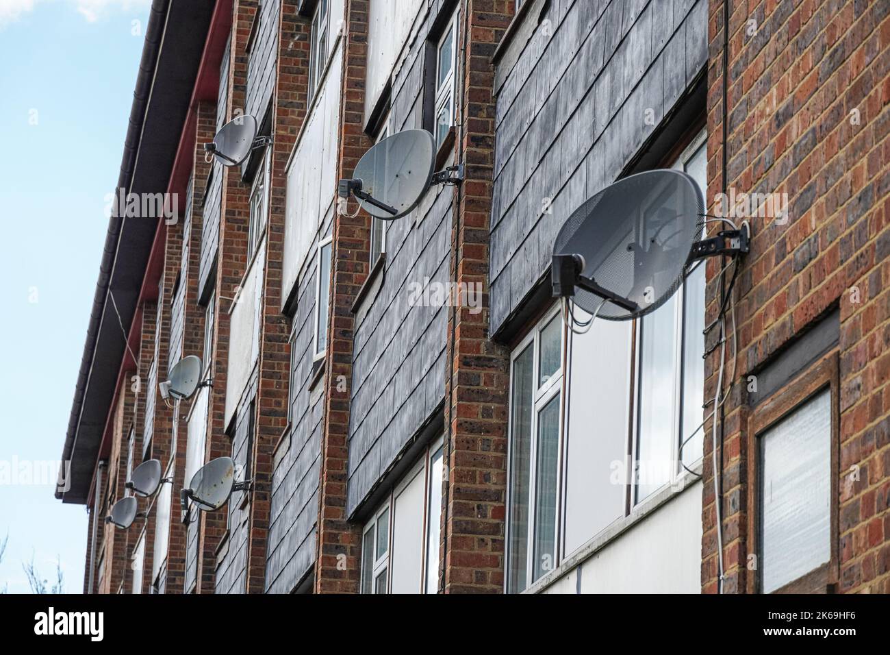 Satellite dishes on a wall of residential block, London, England United Kingdom UK Stock Photo
