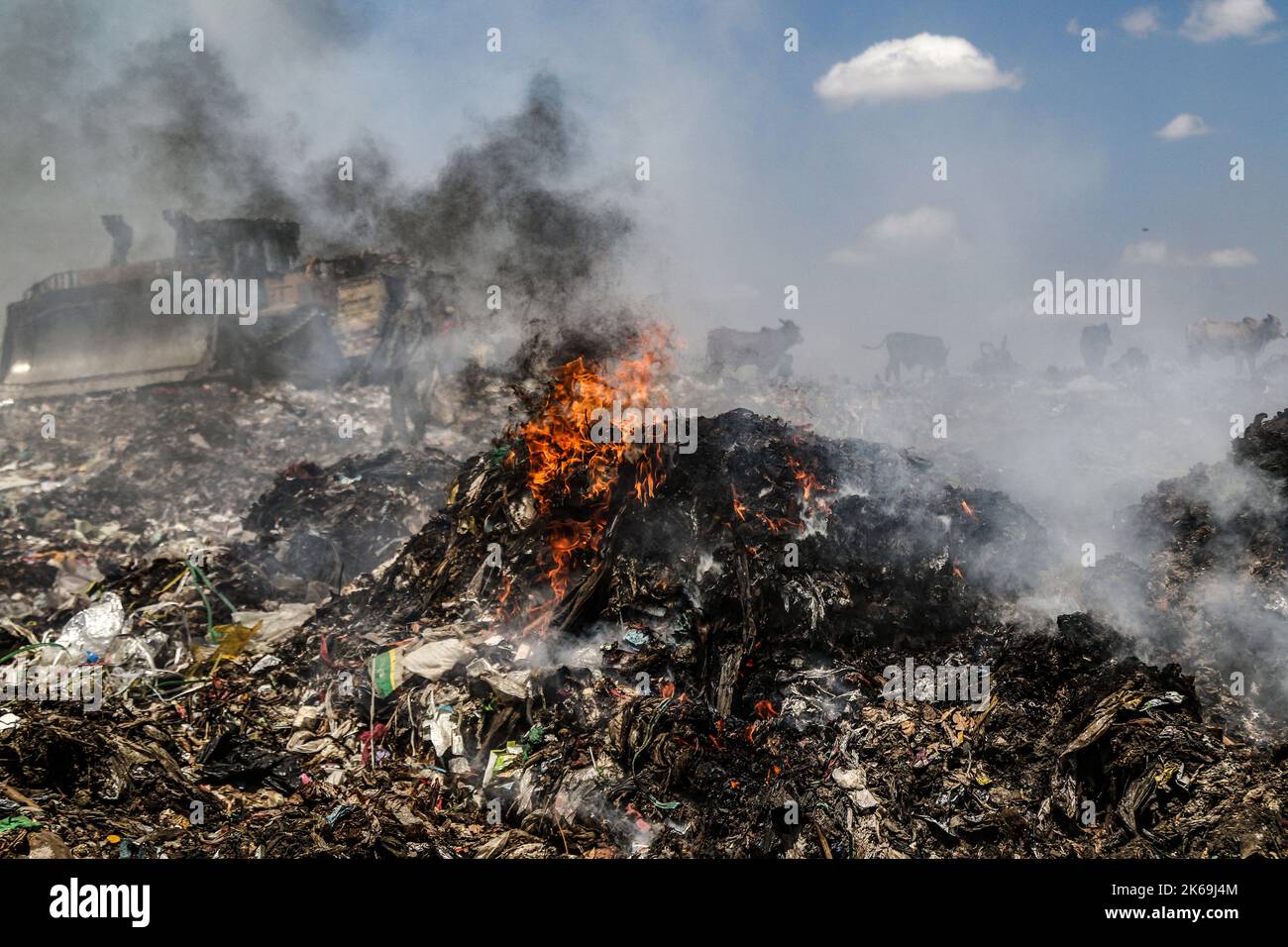 Smoke rises from burning rubbish at Dandora Dumping Site. There are