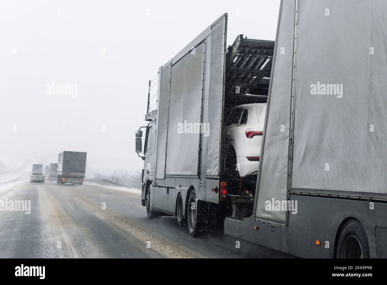 Tow truck car carrier semi trailer on highway carrying batch of new