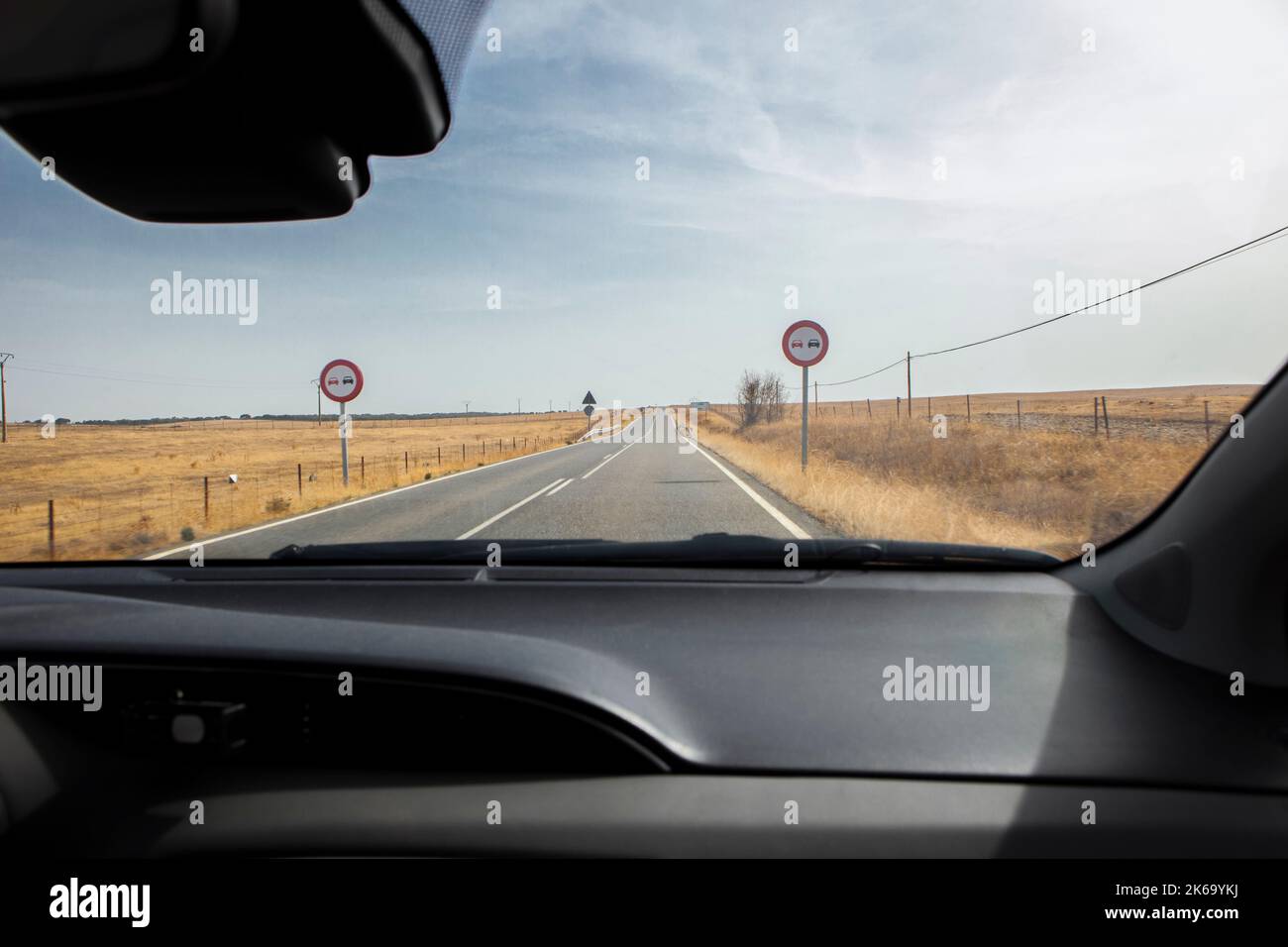 Banned overtakes signals and  continuous line. View from the inside of the car Stock Photo