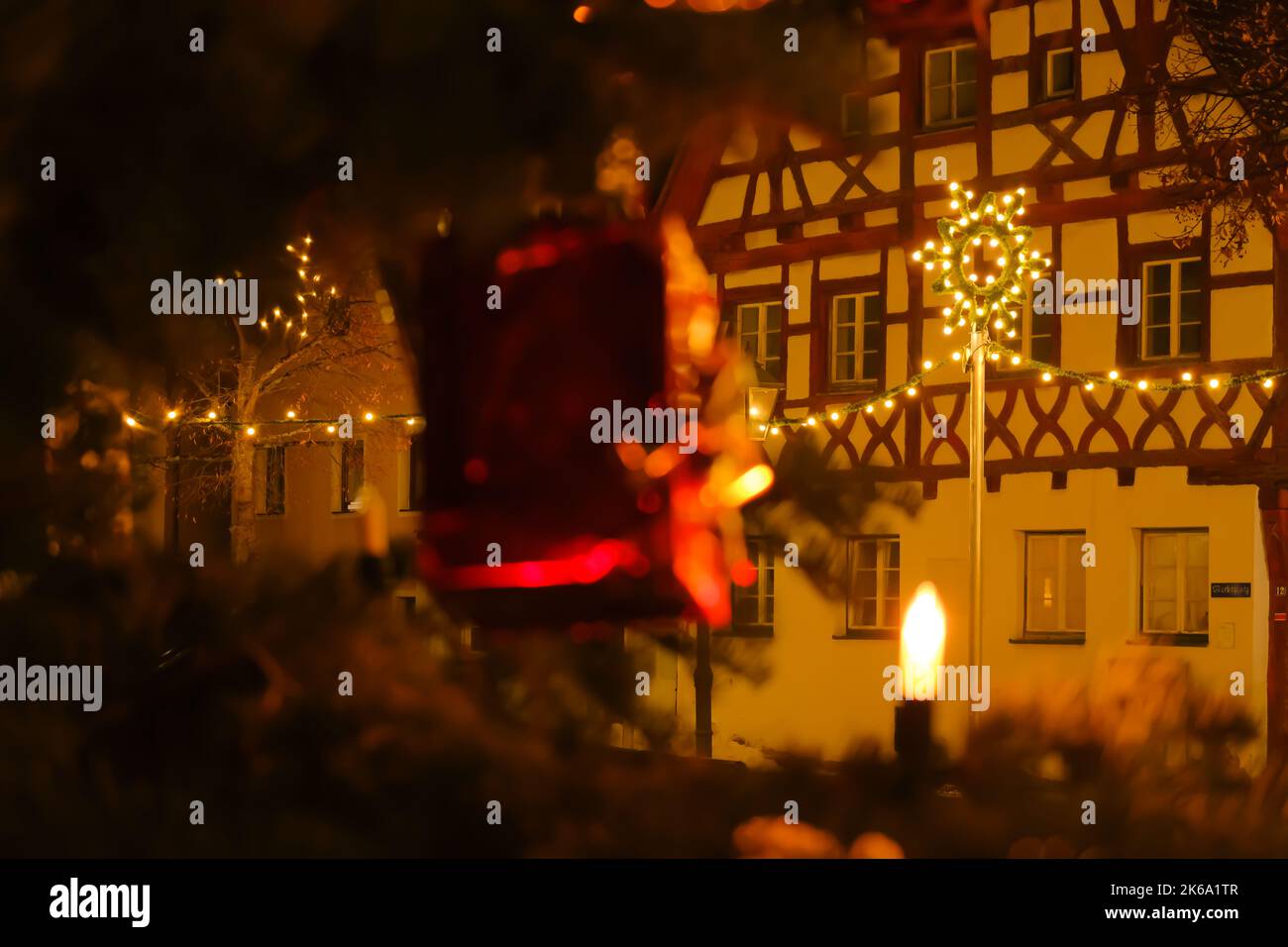 Christmas illumination . half timbered houses and festive decorations.Christmas in Europe.Decorative yellow flashlight and shimmering garland  Stock Photo