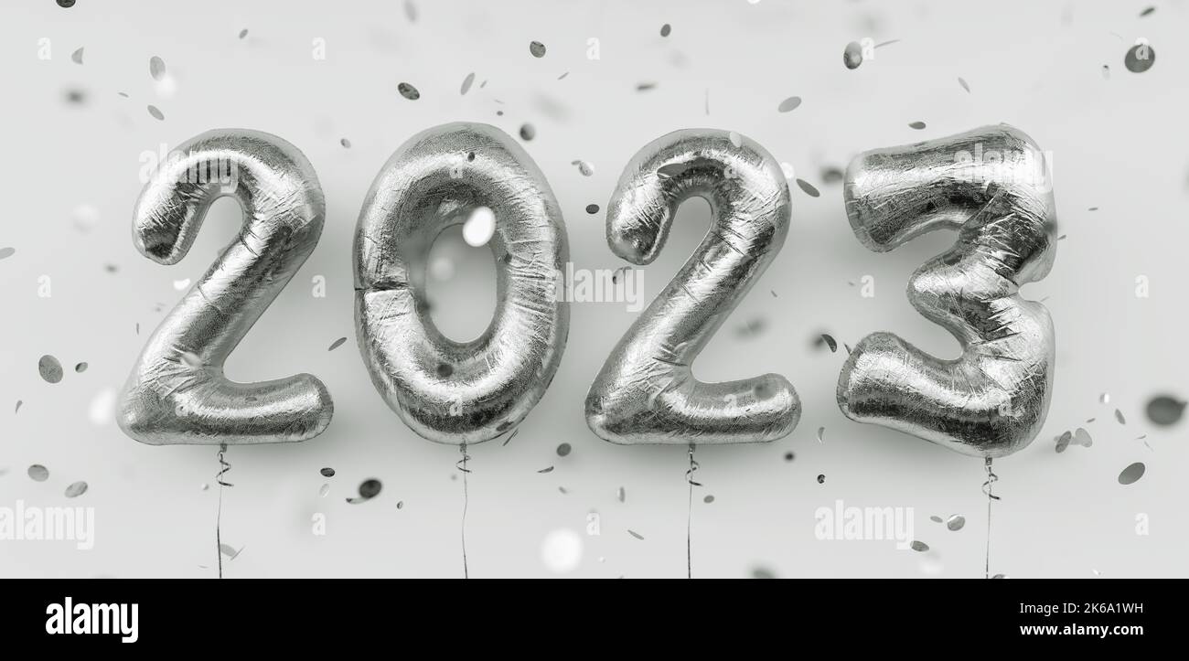 Happy New 2023 Year. 2023 silver foil balloons and falling confetti on white background. Gold helium balloon numbers. Festive poster or banner concept Stock Photo