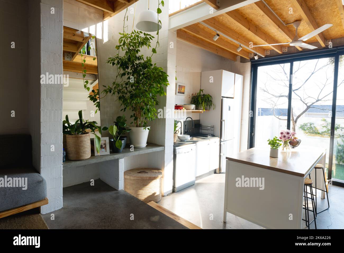 General view of modern kitchen with countertop, kitchen equipment and window Stock Photo