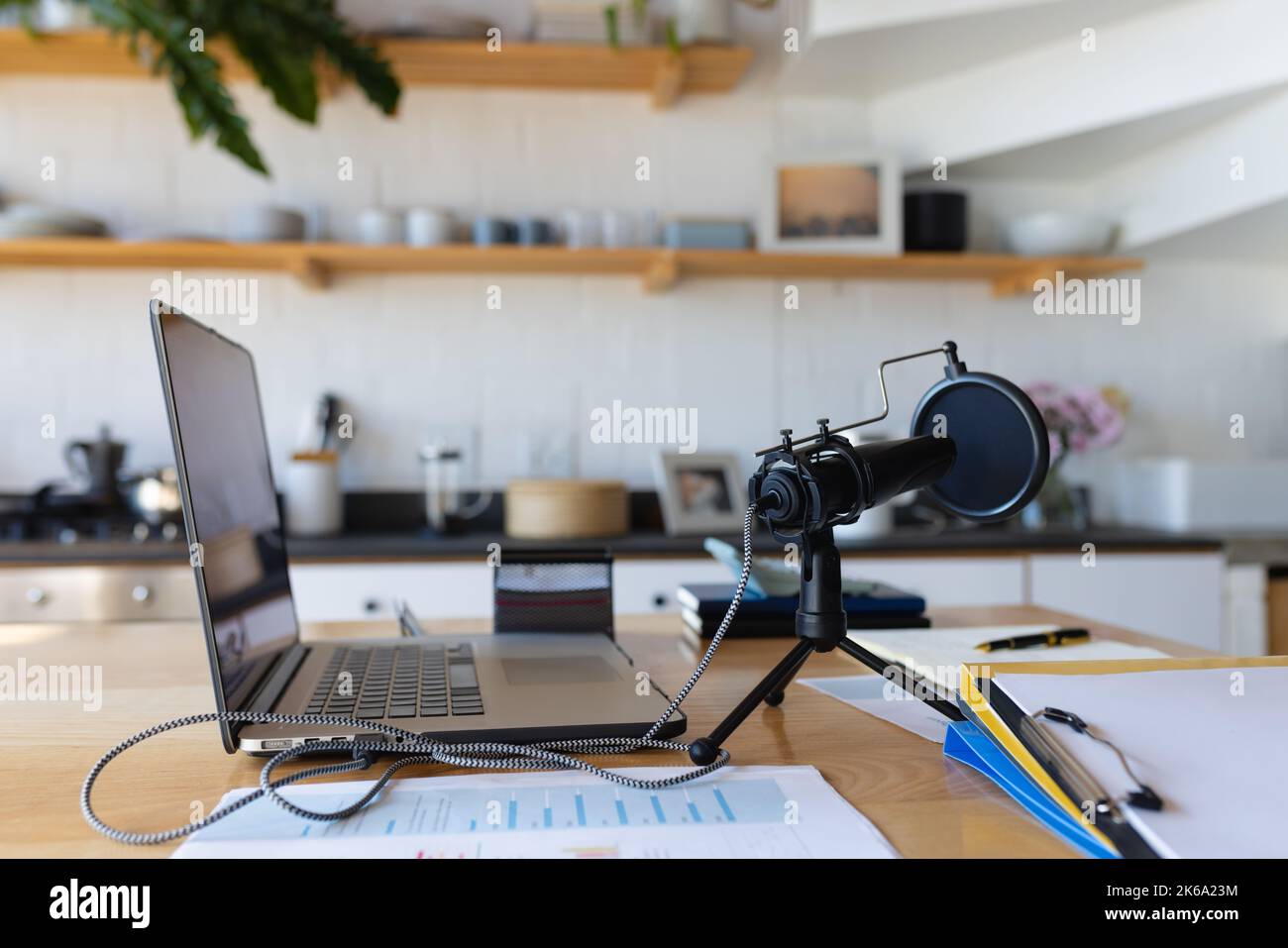 Close up of countertop with laptop and microphone in kitchen Stock Photo