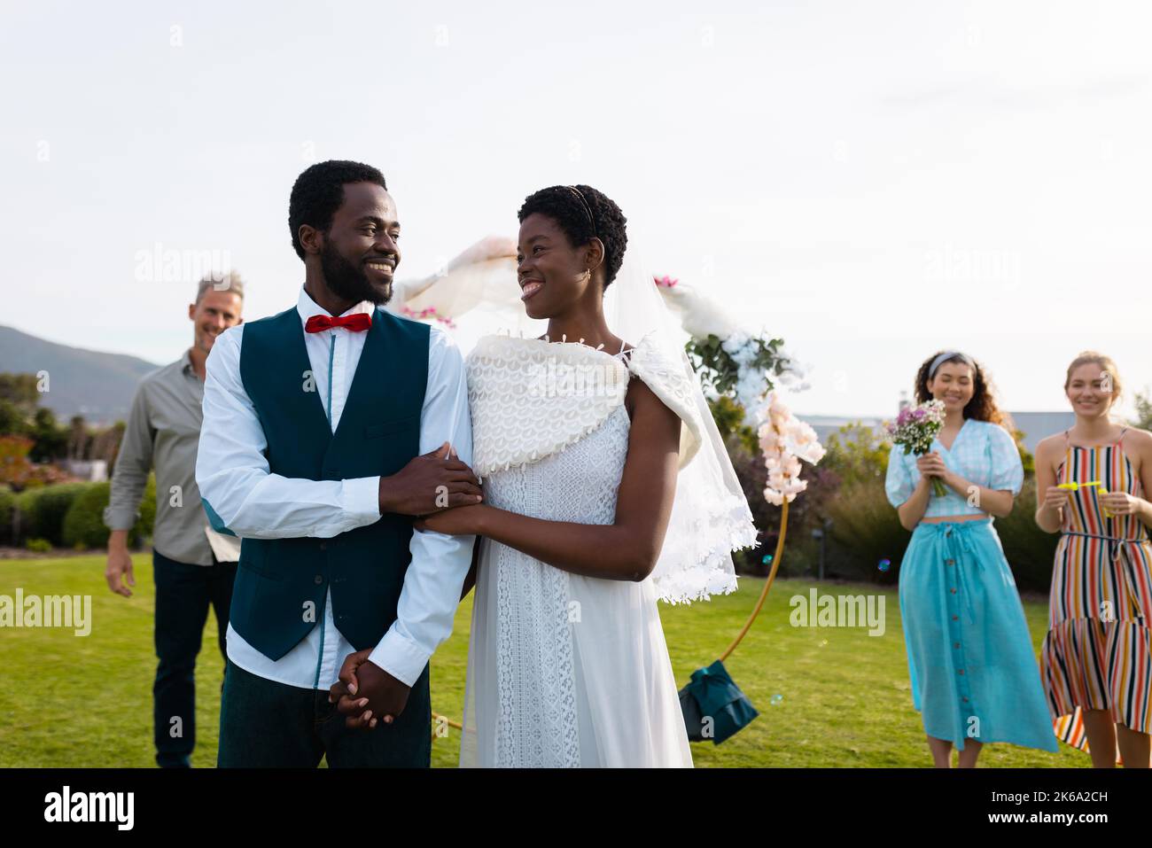 Happy african american couple holding hands during wedding Stock Photo ...