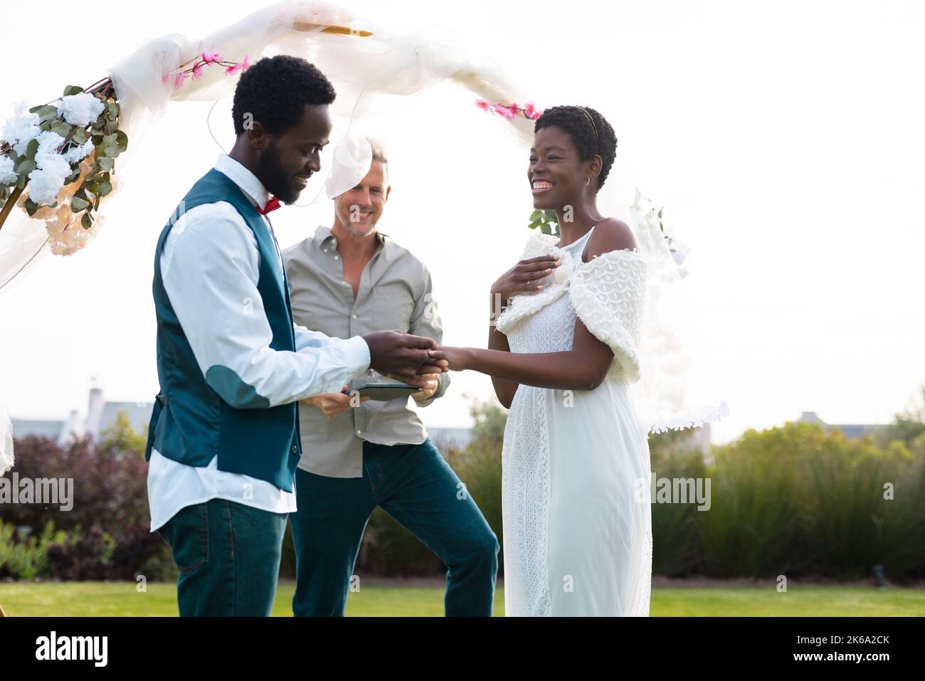 Happy african american couple holding hands during wedding Stock Photo ...