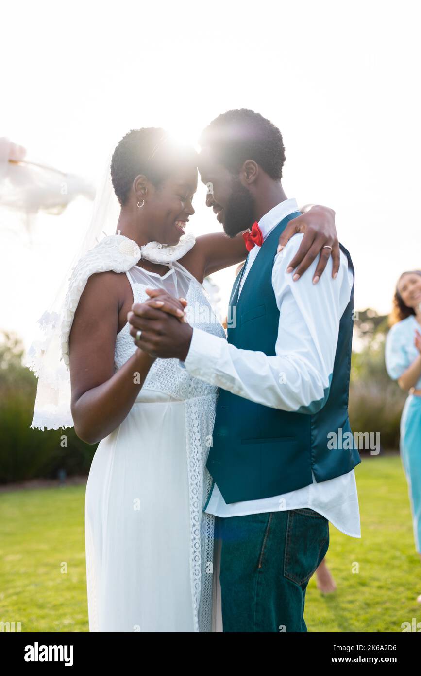 Happy african american couple holding hands during wedding Stock Photo ...