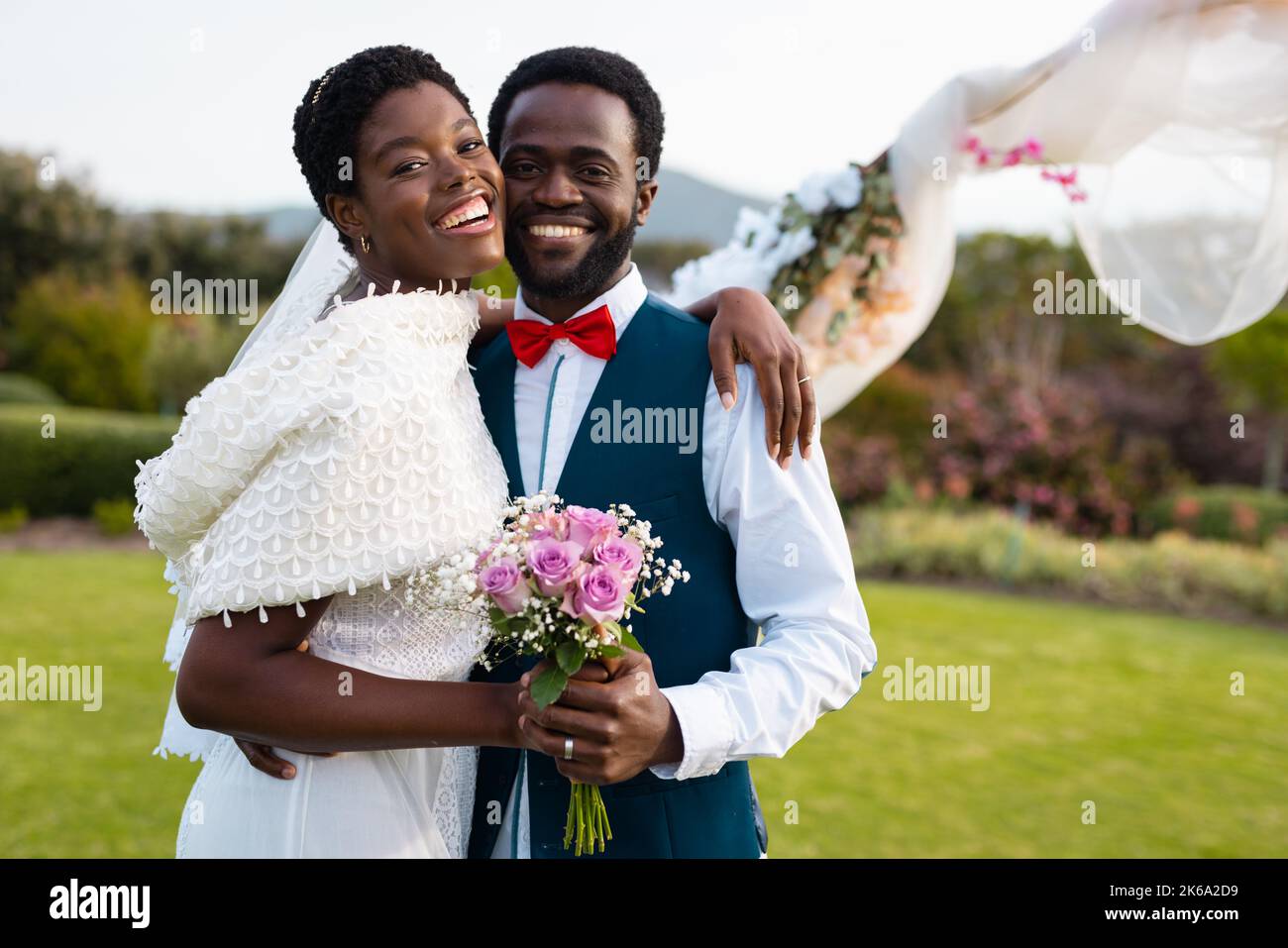 Portrait of happy african american couple holding hands during wedding ...