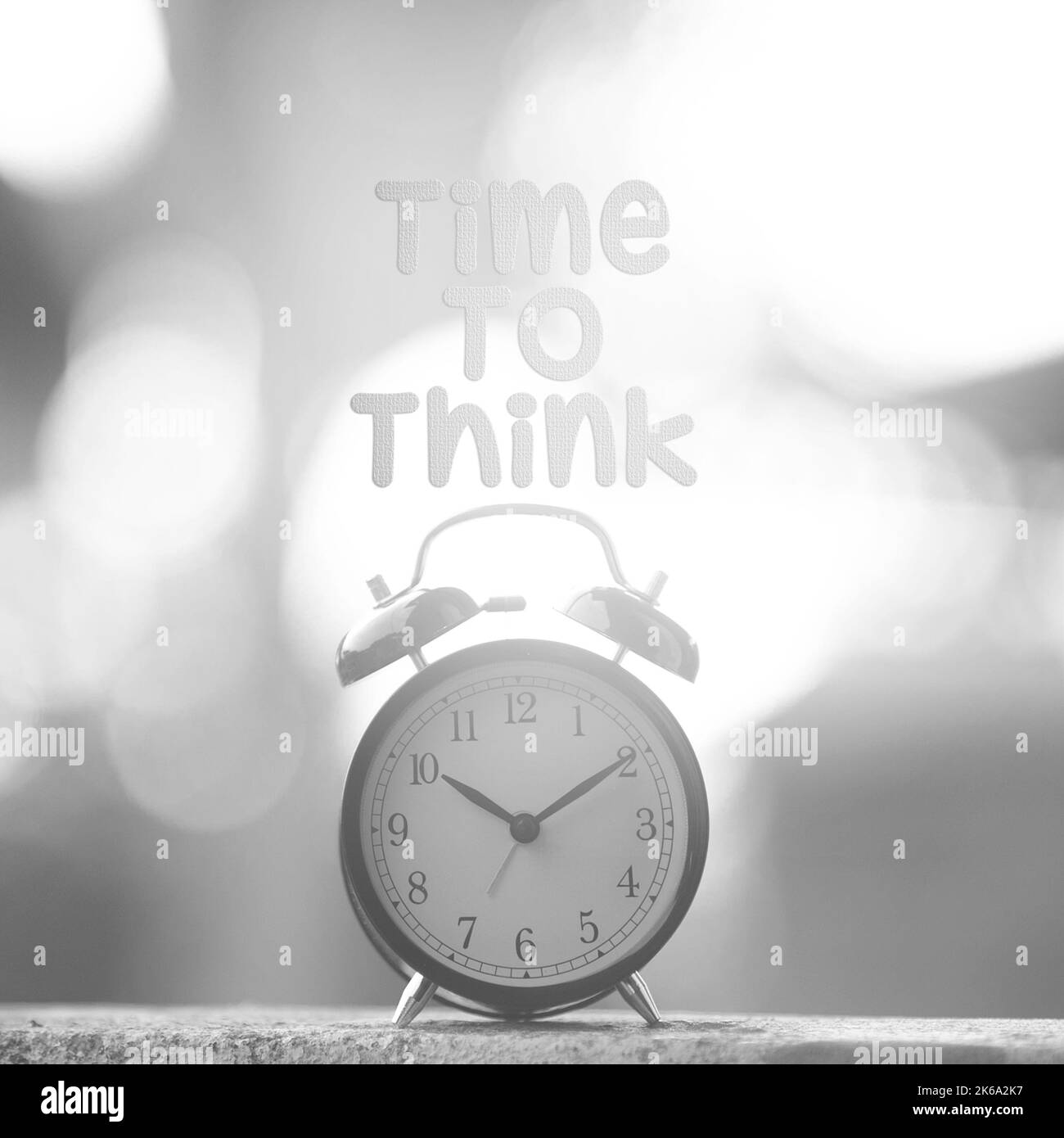 Black alarm clock with time to think word concept of time stock