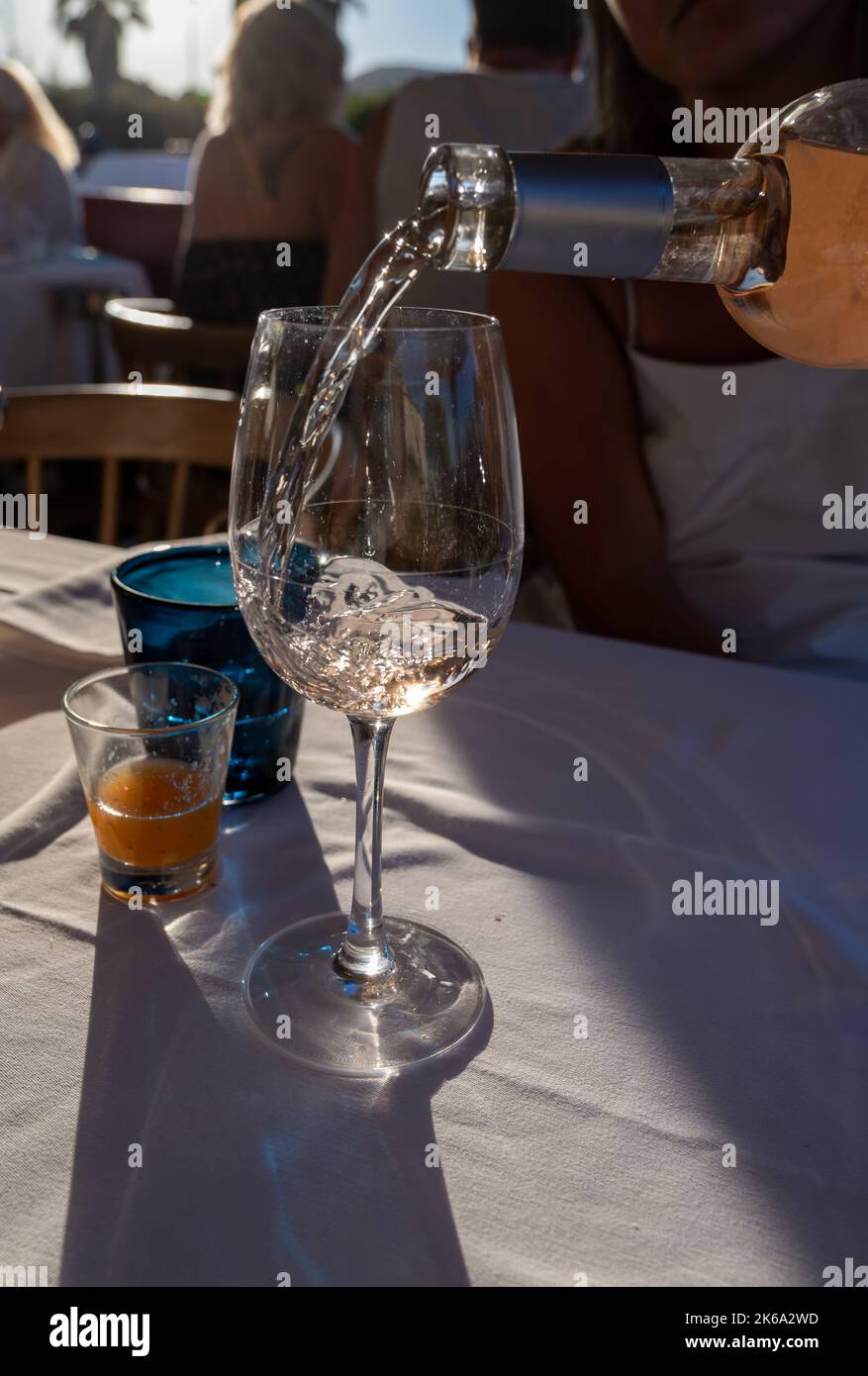 Dinner at sunset in French gourmet restaurant with cold dry rose wine in Port Grimaud, summer