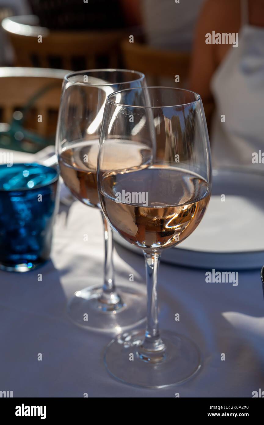 Dinner at sunset in French gourmet restaurant with cold dry rose wine in Port Grimaud, summer