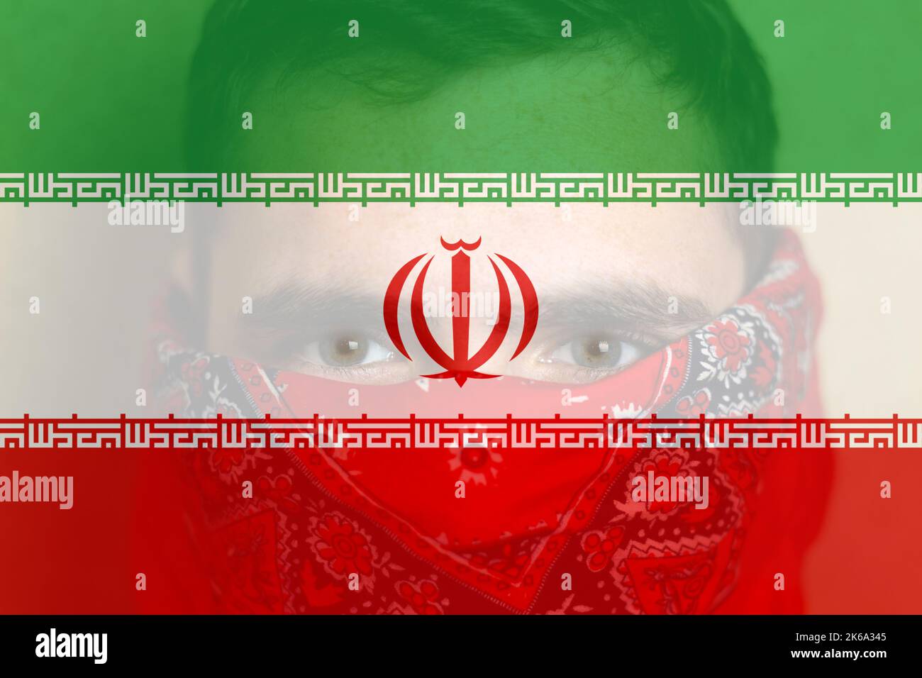 Defocus protest in Iran. Face young man in bandana. Conflict war over border. Closeup man face. Country flag. Iran flag. Out of focus. Stock Photo