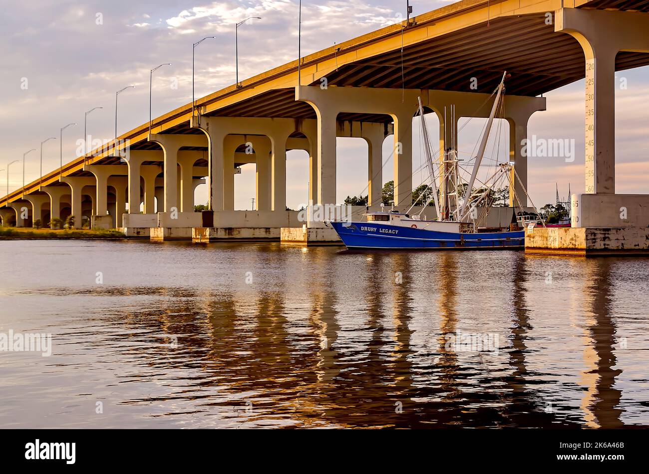 A shrimp boat travels along the Pascagoula River beneath the Pascagoula
