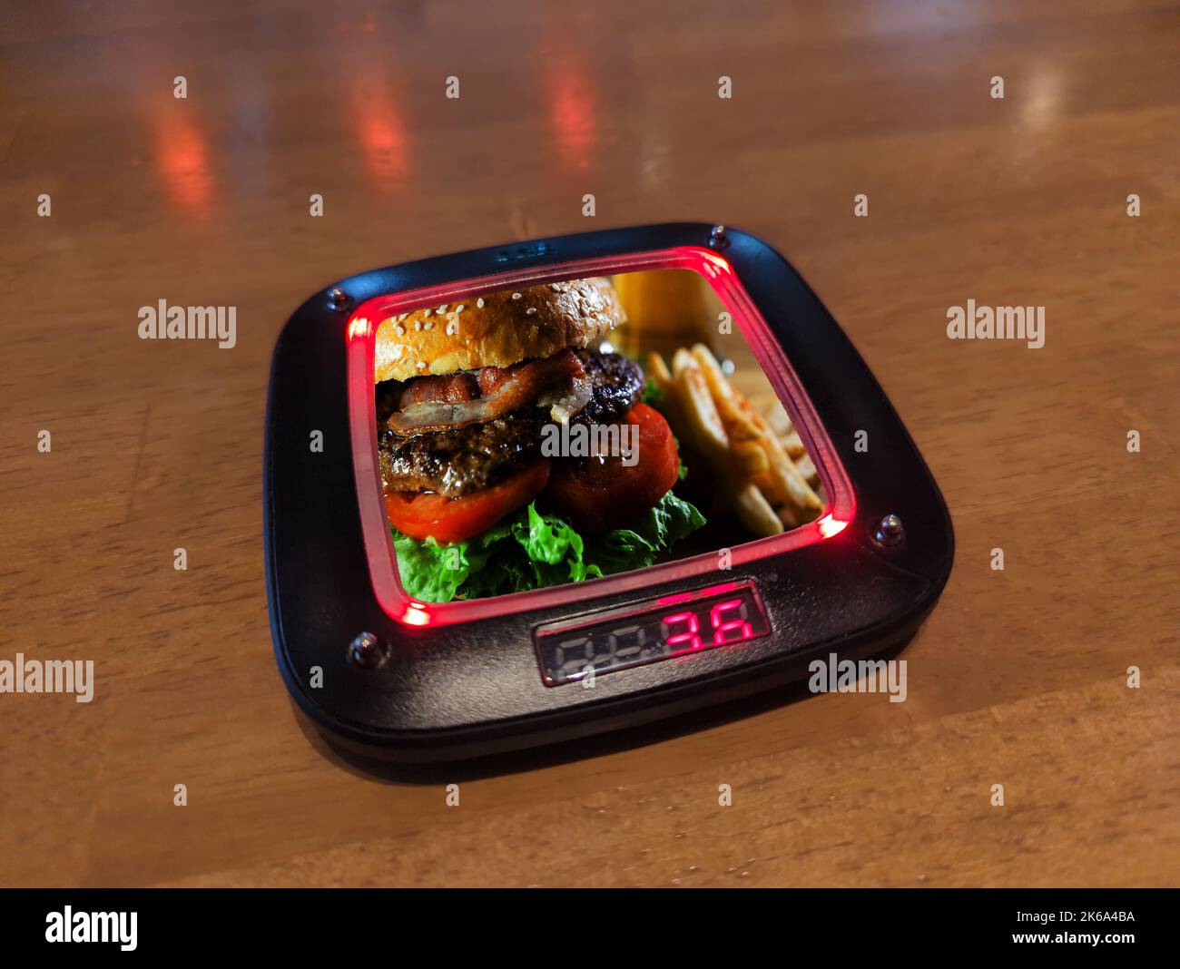 Restaurant pager with warning lights lit indicating diners order is ready. Stock Photo