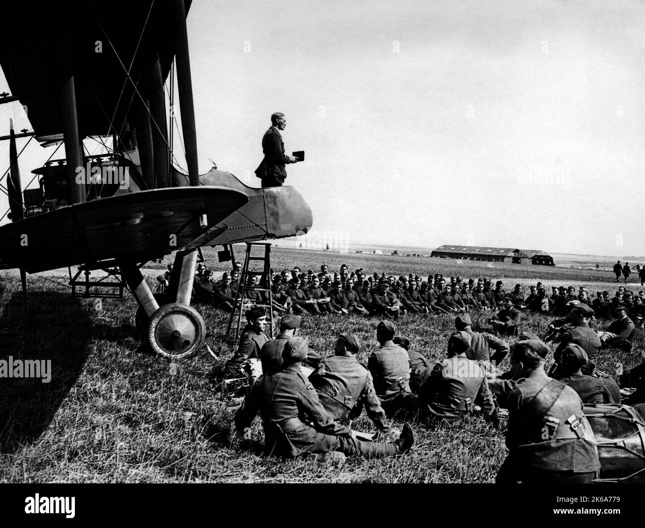 An Army chaplain giving a service to soldiers from the front cockpit of a plane, France. Stock Photo