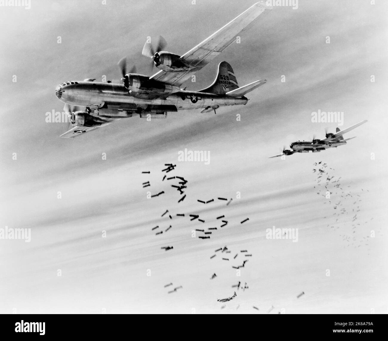 A pair of B29 Superfortress bombers dropping bombs during World War II