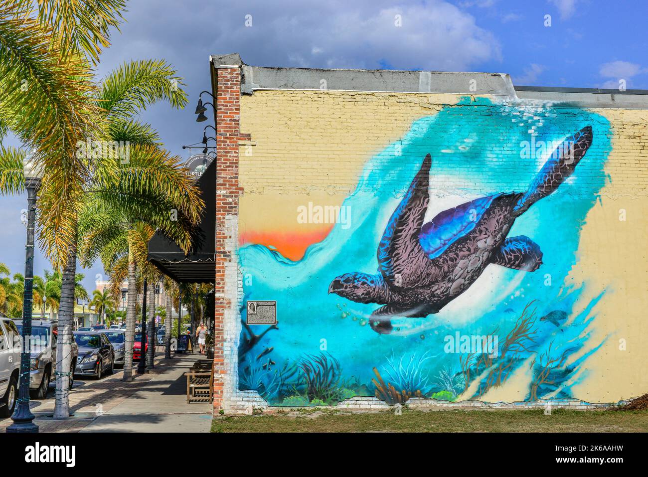 A colorful turtle mural on the old brick building housing the trendy fine dining restaurant, The Turtle Club, in downtown Punta Gorda, FL, USA Stock Photo