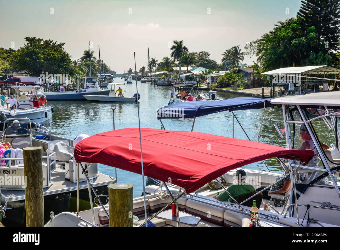 Crowded canal with partying boaters near Phuzzys Boat Shack restaurant & bar in St. James City