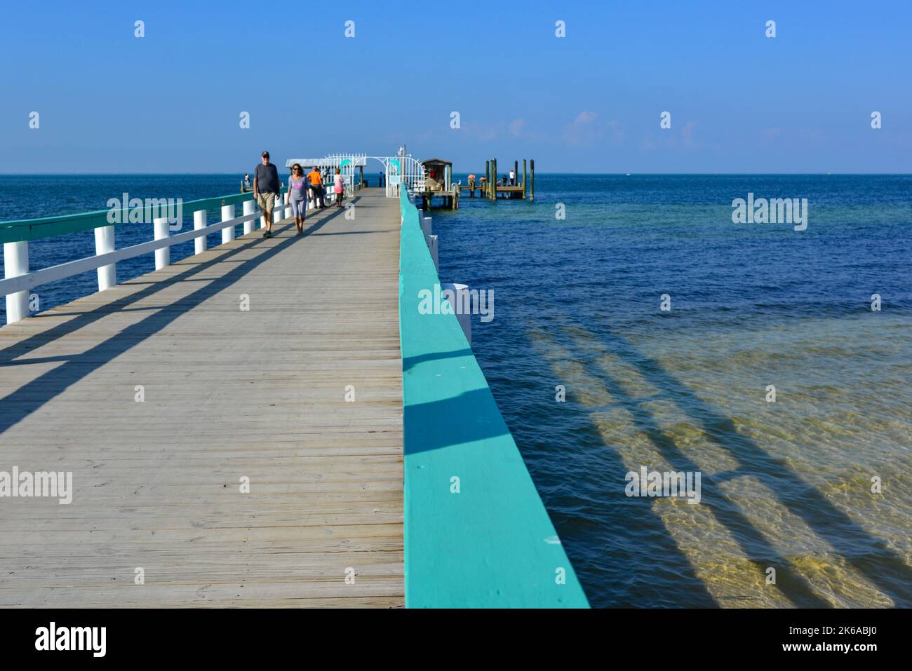 A couple enjoy the Bokeelia Fishing Pier located on the northern tip of Pine Island, Florida on the Charlotte Harbor before Hurricane Ian Stock Photo