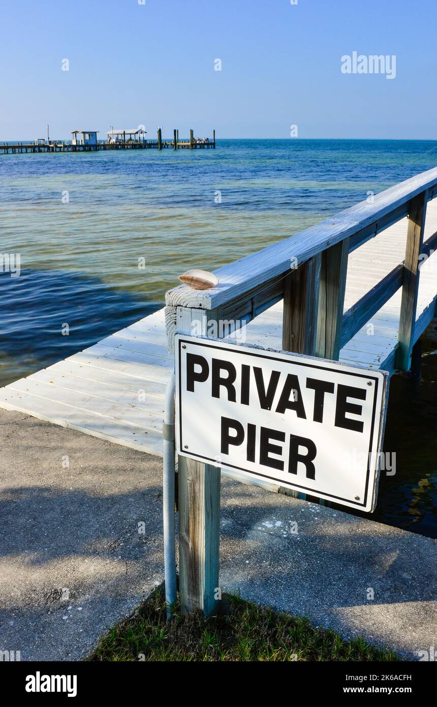 Sign for one of many private piers jutting out into the Charlotte Harbor on Pine Island in Lee County, Florida before Hurricane Ian devastated area Stock Photo