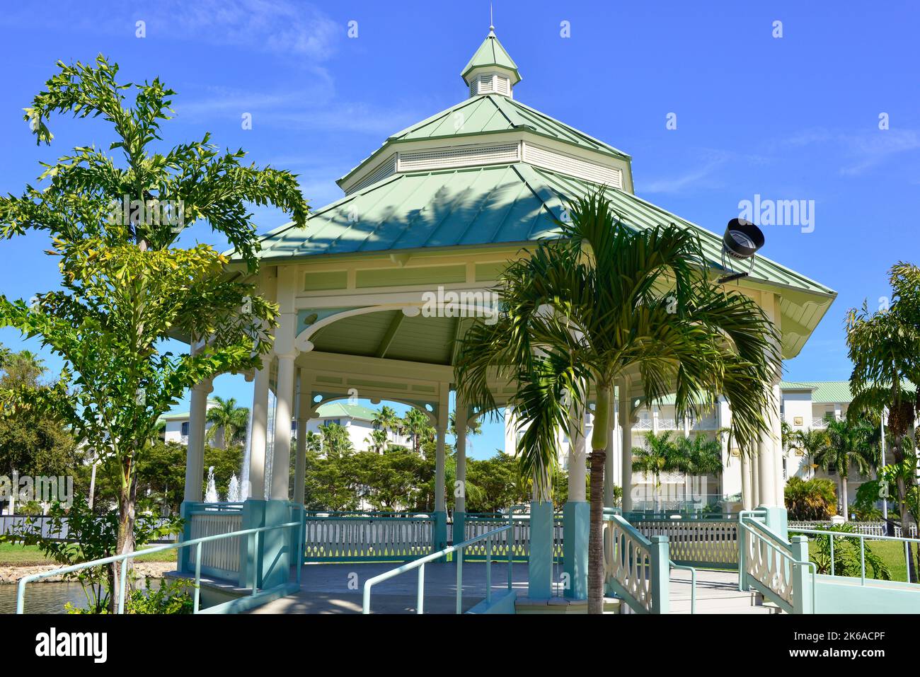A charming gazebo with palms trees surround a lake with the Fountain of Freedom, remembering the Veterans in Laishley Park in Punta Gorda, FL, USA, Stock Photo