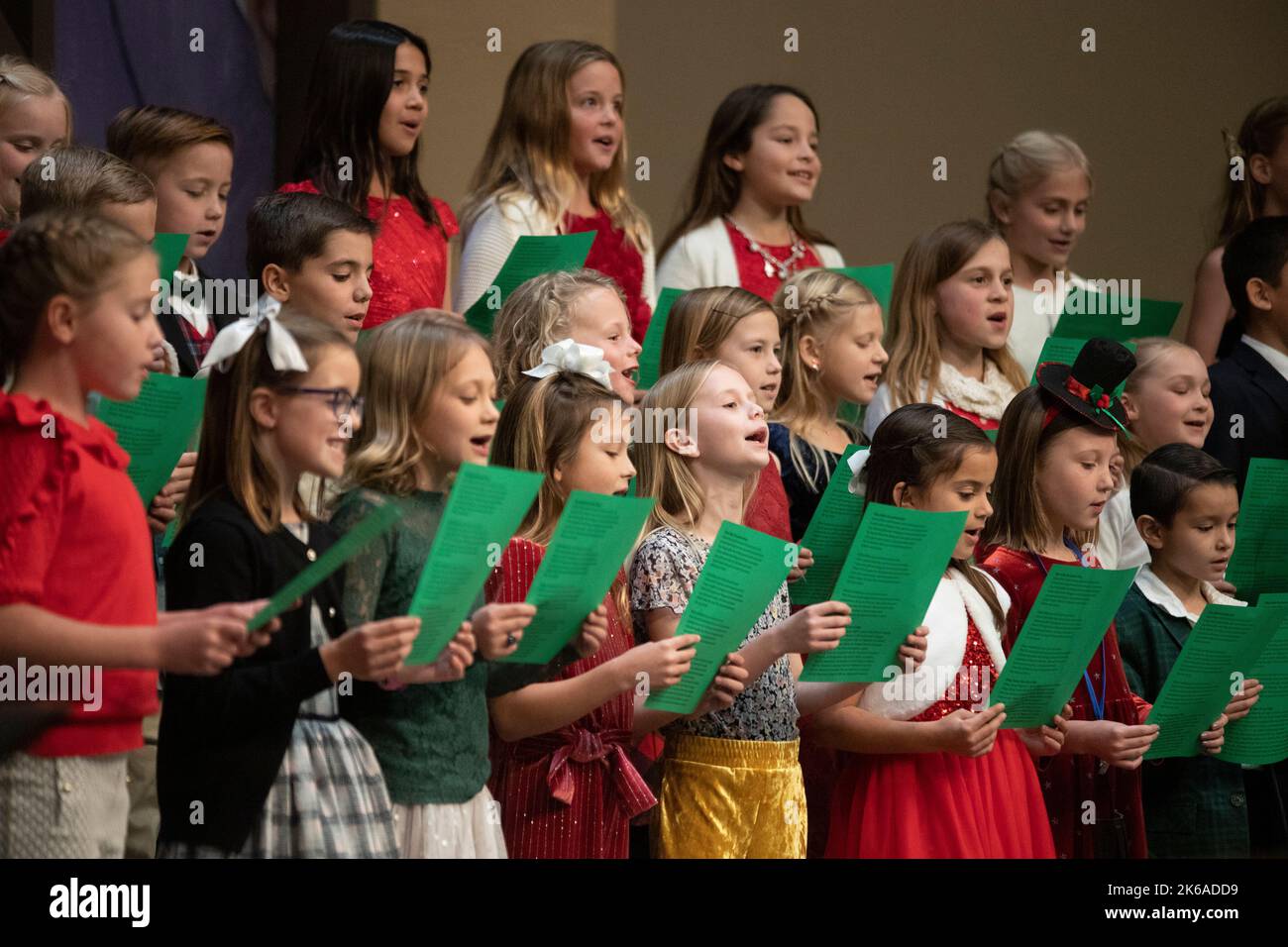 Holding lyric sheets, girls sing in a Christmas choir at a Dana Point, CA, Catholic church Stock