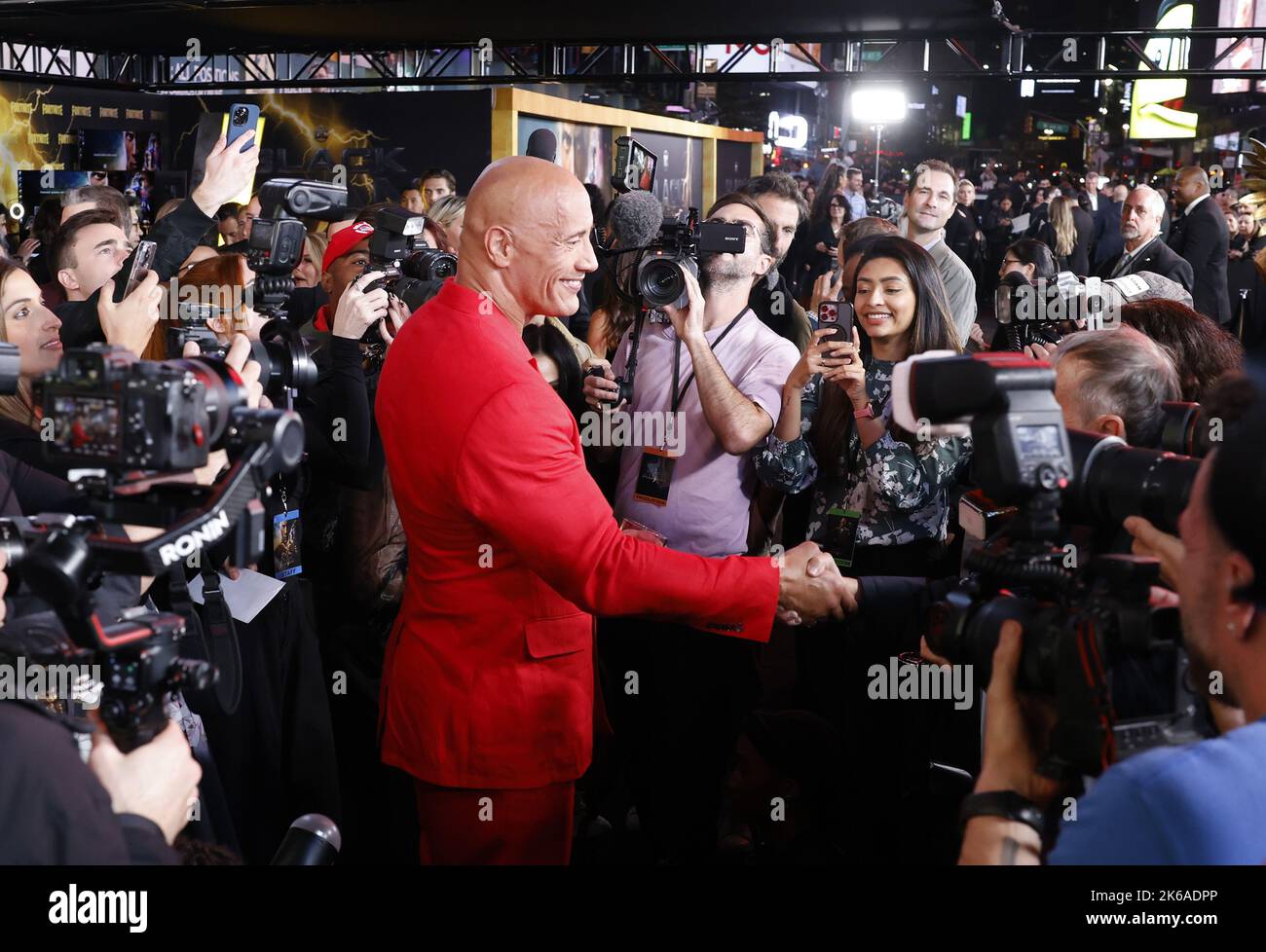 New York, United States. 12th Oct, 2022. Dwayne 'The Rock' Johnson greets a photographer friend when he arrives on the red carpet for DC's 'Black Adam' New York Premiere at AMC Empire 25 in Times Square on October 12, 2022 in New York City. Photo by John Angelillo/UPI Credit: UPI/Alamy Live News Stock Photo