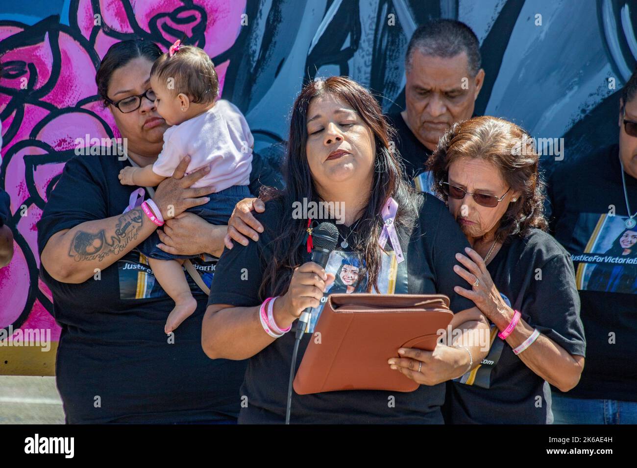 Emotional Santa Ana, CA, friends and relatives unveil a tribute billboard to a young Hispanic woman murdered by an unknown killer. Stock Photo