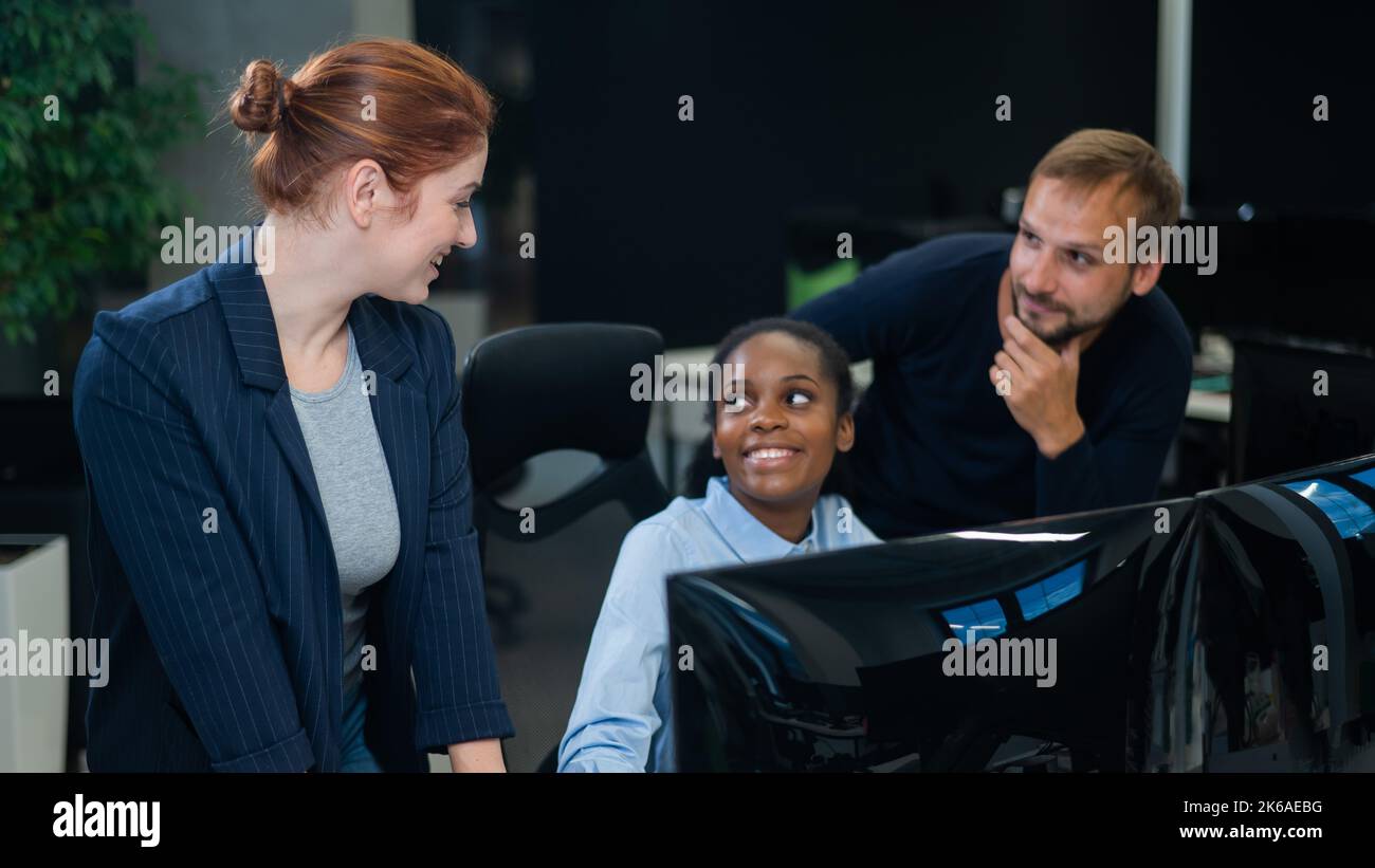 Colleagues look at the monitor and decide working moments. African ...