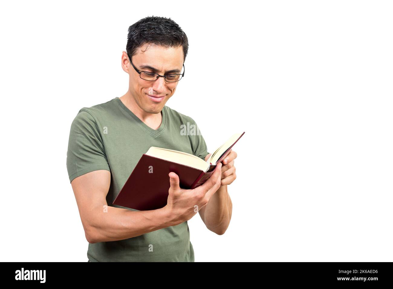 Smiling clever man in eyeglasses reading book Stock Photo