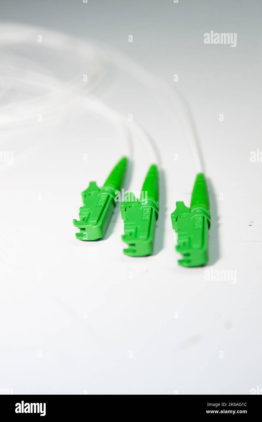 Green fiber optic E2000 connector on white background Stock Photo