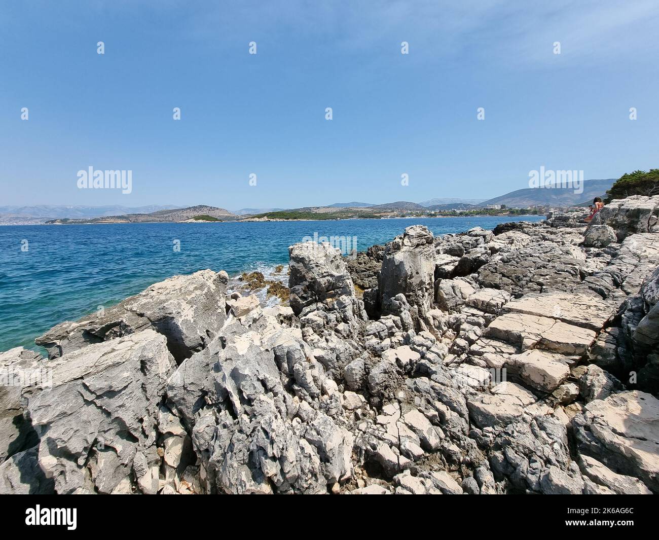 The waves crashing into rocky beach with mesmerizing landscapes of mountain ranges and coastline