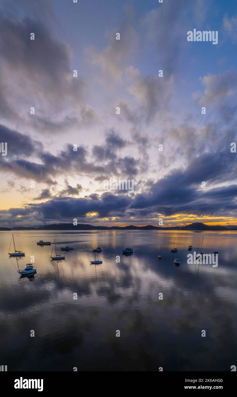 Sunrise reflections over Brisbane Water at Koolewong and Tascott on the Central Coast, NSW, Australia. Stock Photo