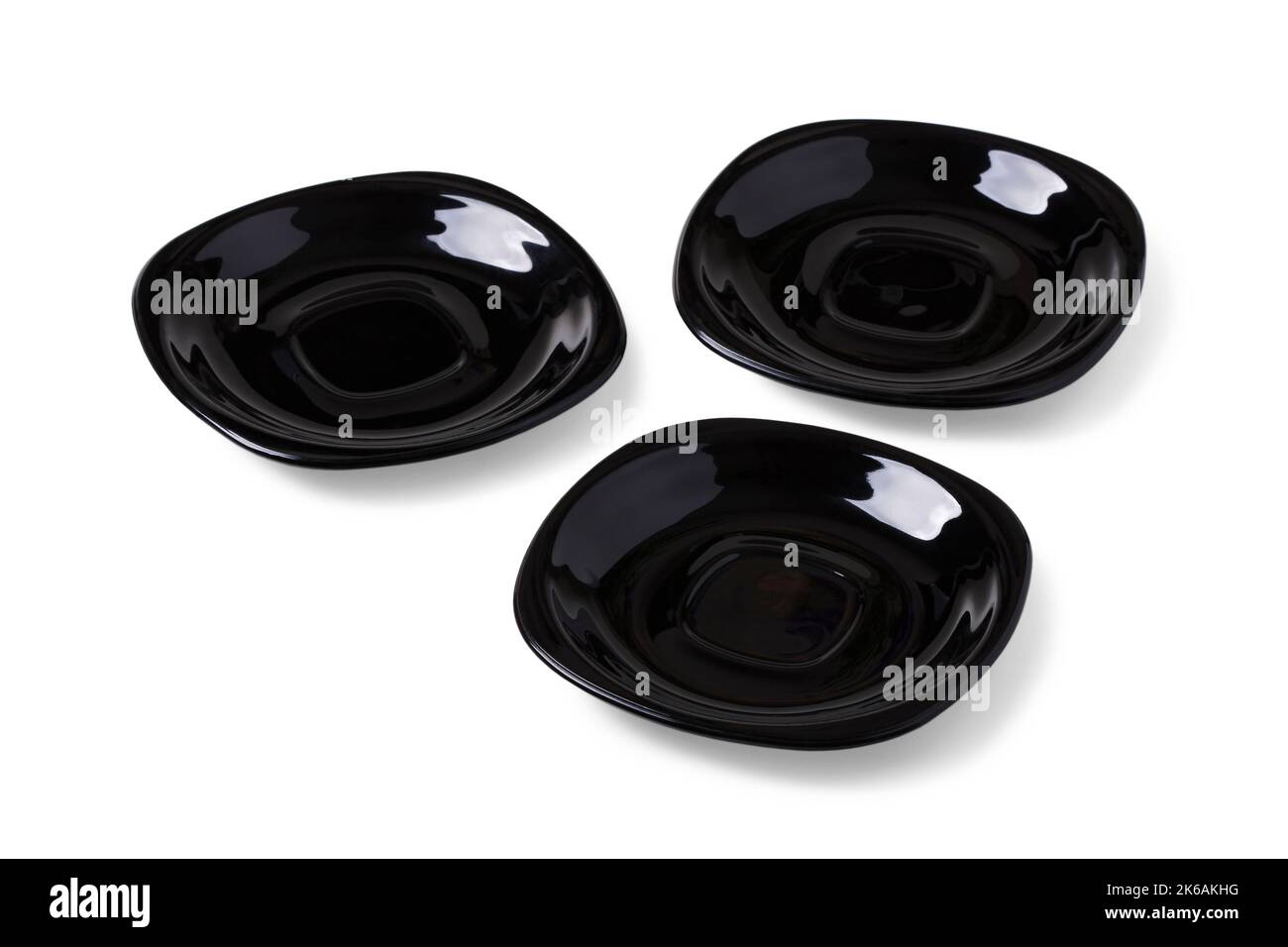 Three black ceramic saucers isolated on white Stock Photo