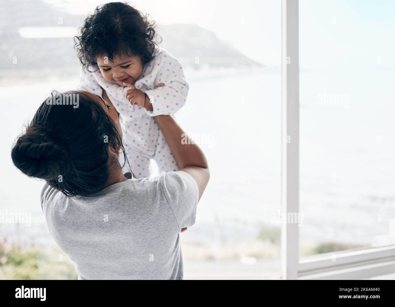 The little friend she never knew she needed. a mother holding her baby daughter at home. Stock Photo