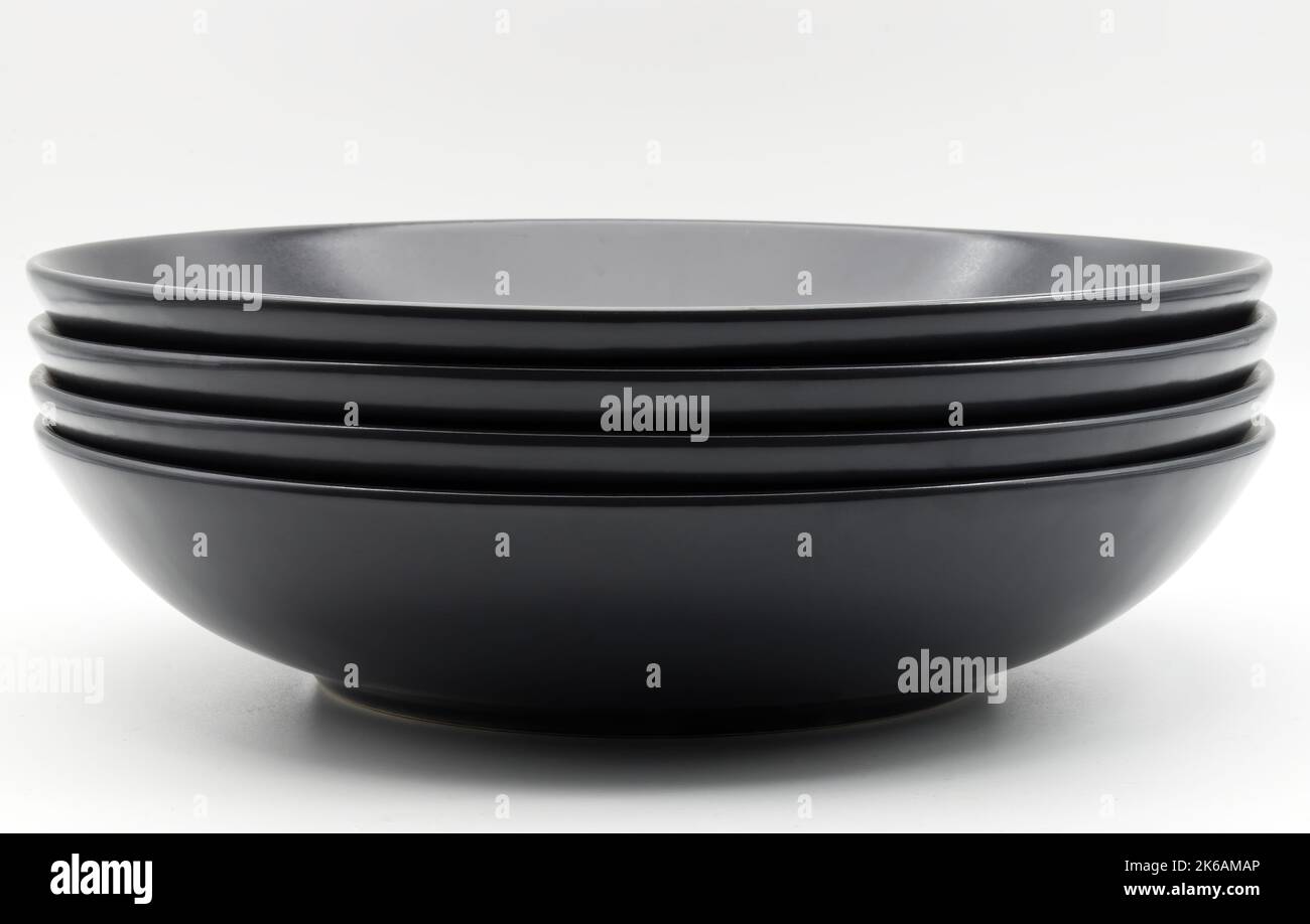 Stack of black dishes isolated on white background Stock Photo Alamy