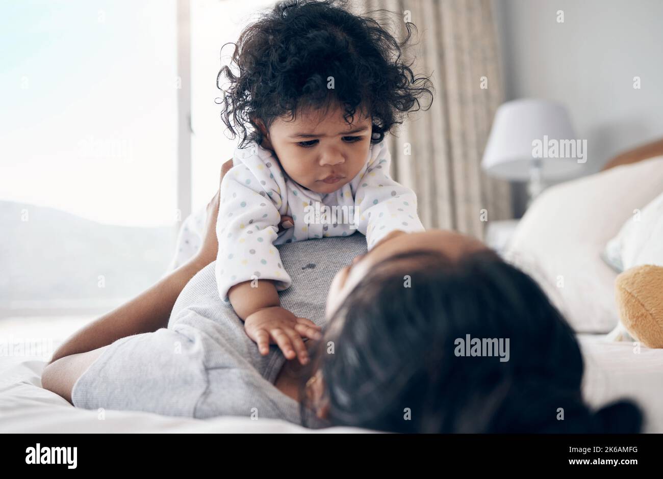 When will you sleep. a young mother bonding with her baby girl in bed at home. Stock Photo