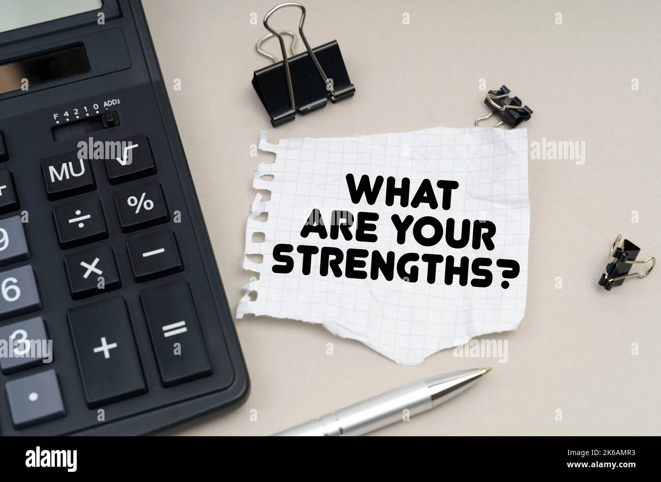 Business and finance concept. On the table is a calculator, a pen and paper with the inscription - What Are Your Strengths Stock Photo